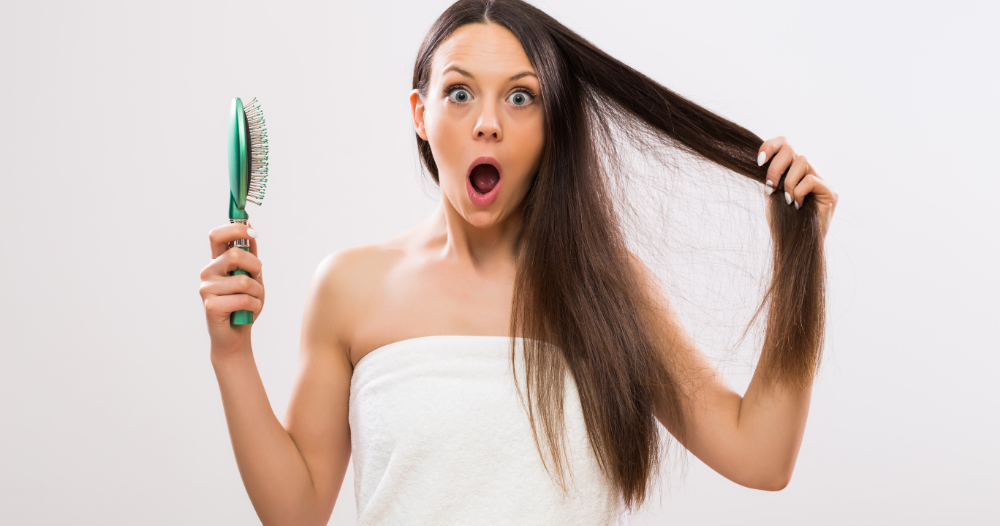 ragazza con spazzola triste per la caduta dei capelli
